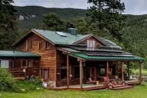 evergreen colorado home with solar panels and green mountains in background