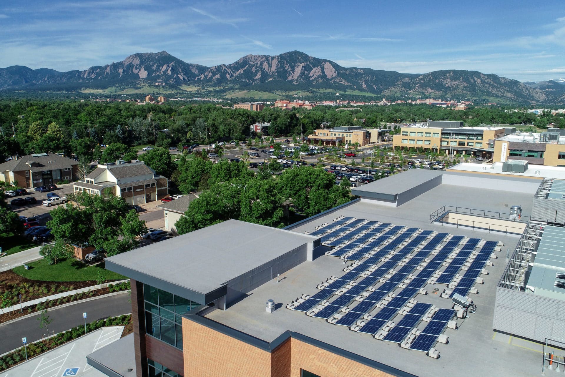 solar panels on rooftop with boulder flatirons in background
