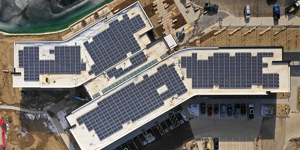 rooftop solar array with denver colorado skyline in background